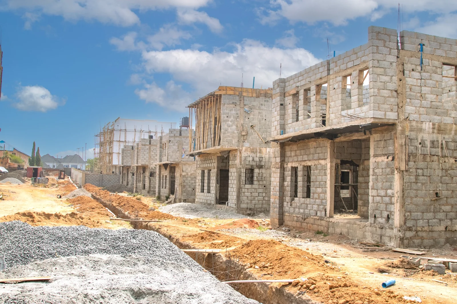Ongoing Syrol Homes construction showing a row of multi-unit residential buildings in progress