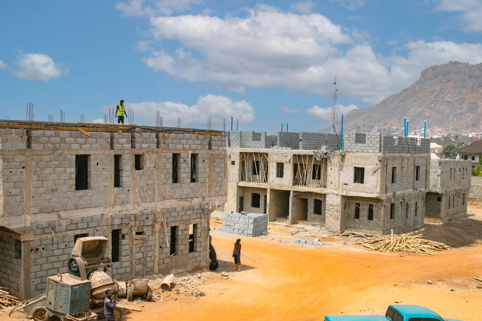 Residential building under construction with a loader in front